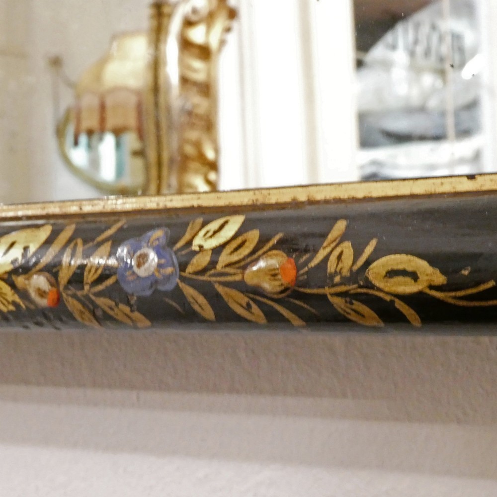 An arched wall mirror with a dark lacquered frame featuring gilded Chinoiserie motifs and segmented glass plates. View VIII