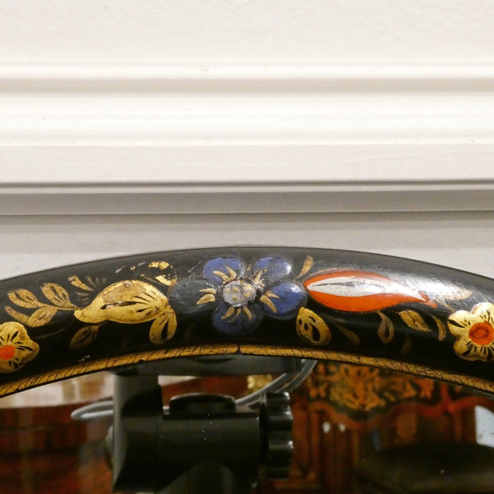 An arched wall mirror with a dark lacquered frame featuring gilded Chinoiserie motifs and segmented glass plates. View XI