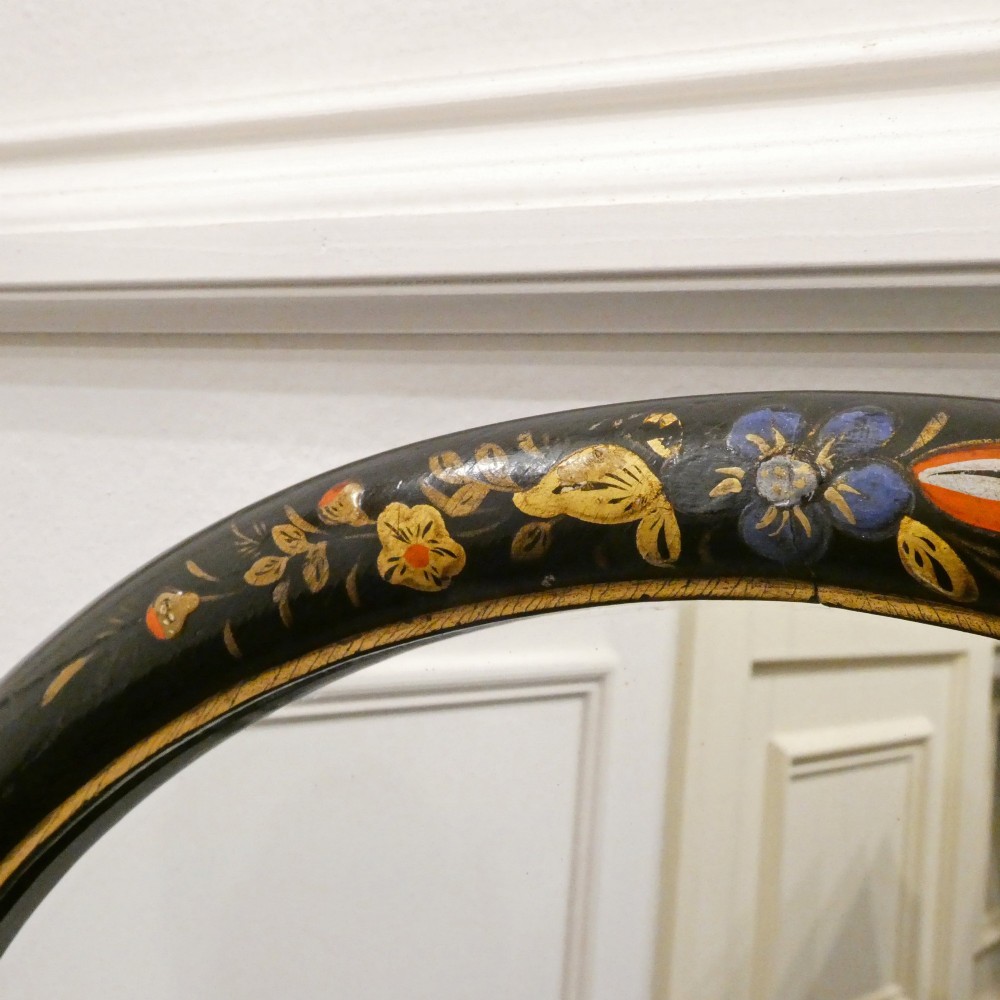 An arched wall mirror with a dark lacquered frame featuring gilded Chinoiserie motifs and segmented glass plates. View XII