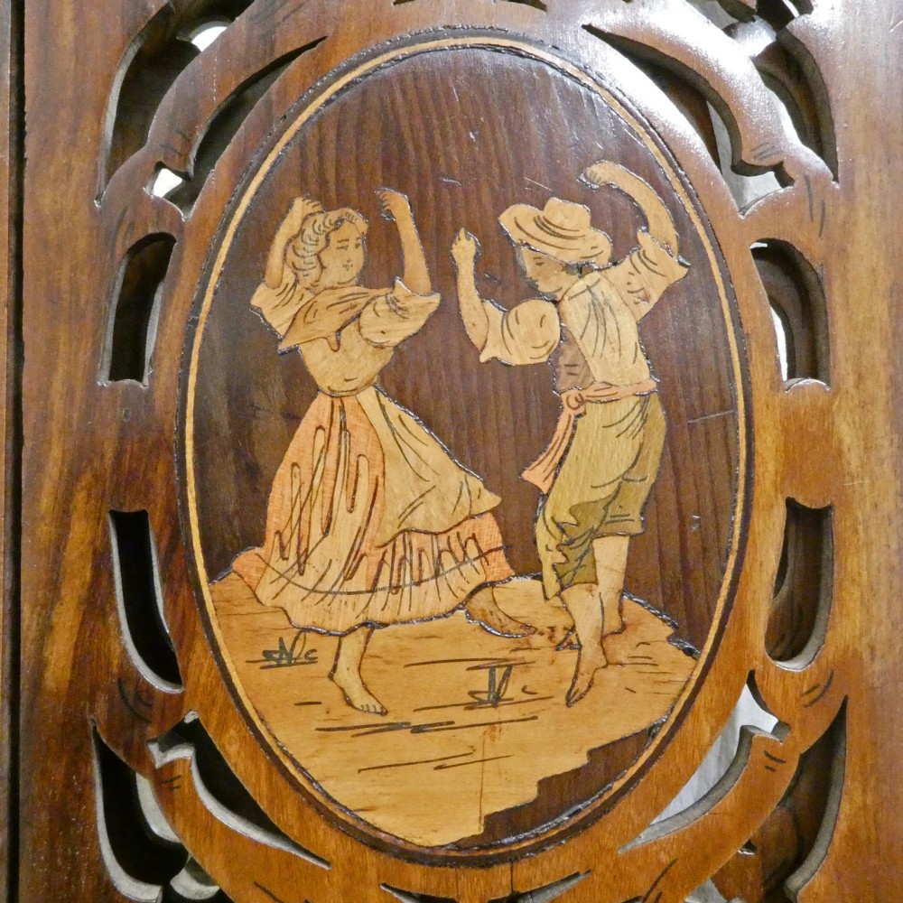 A fretted walnut triptych dressing table mirror featuring central oval glass plates surrounded by openwork carved scroll patterns and inlaid timber panels. View IV