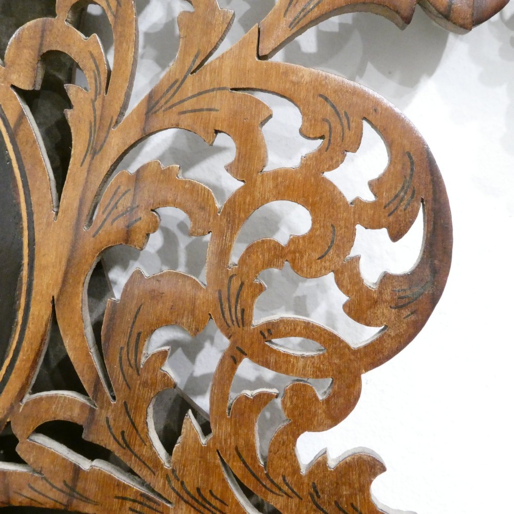 A fretted walnut triptych dressing table mirror featuring central oval glass plates surrounded by openwork carved scroll patterns and inlaid timber panels. View VI