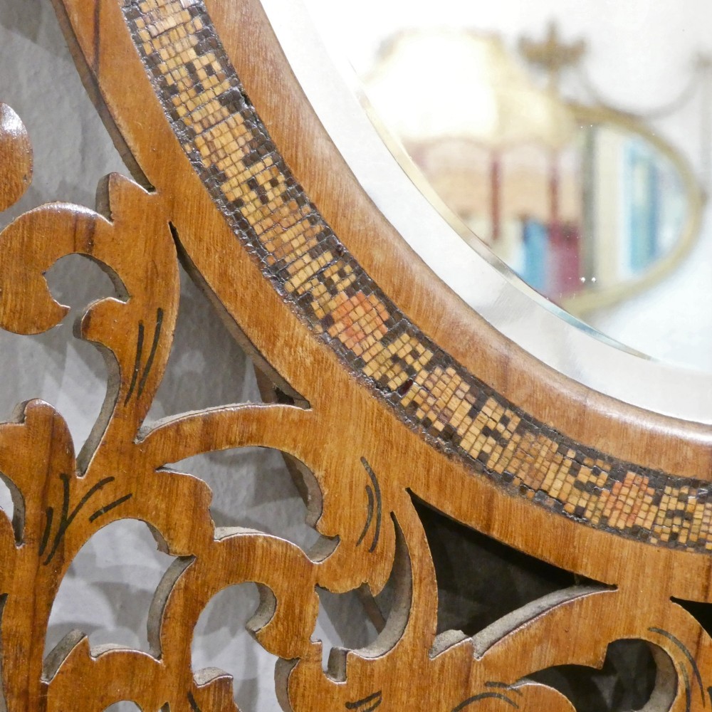 A fretted walnut triptych dressing table mirror featuring central oval glass plates surrounded by openwork carved scroll patterns and inlaid timber panels. View VII
