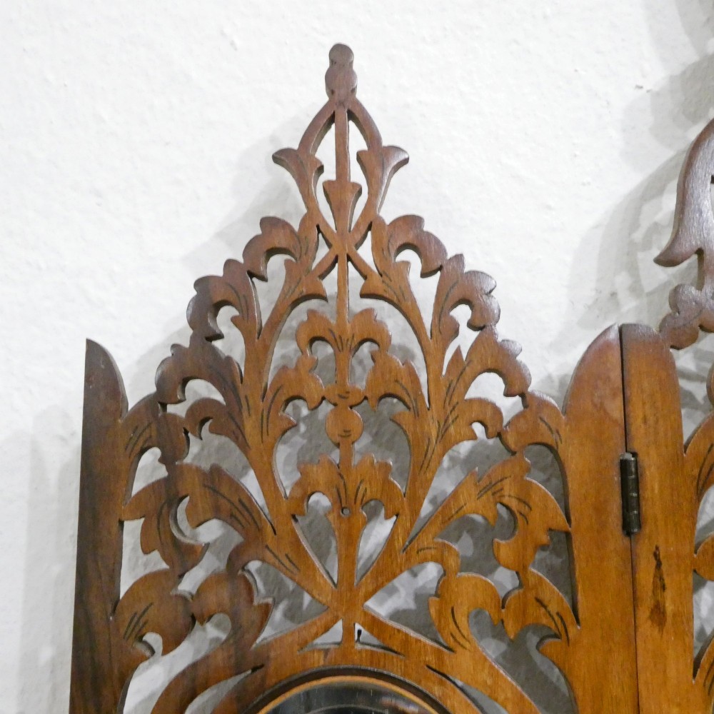 A fretted walnut triptych dressing table mirror featuring central oval glass plates surrounded by openwork carved scroll patterns and inlaid timber panels. View VIII