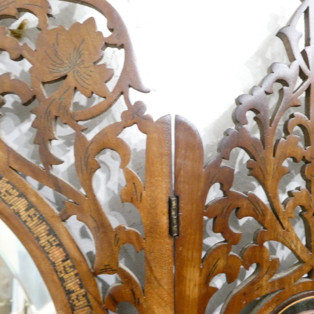A fretted walnut triptych dressing table mirror featuring central oval glass plates surrounded by openwork carved scroll patterns and inlaid timber panels. View IX