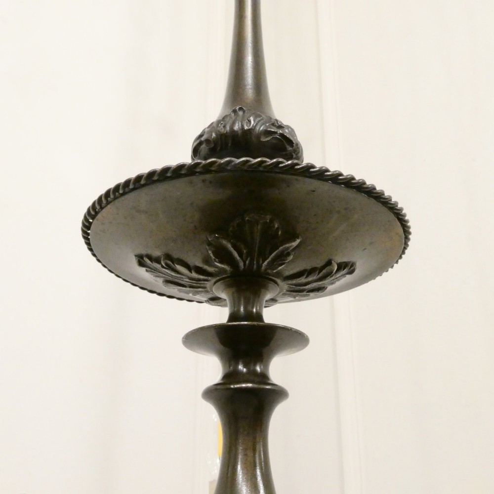 An early 20th-century Dutch bronze two-light chandelier featuring a baluster-turned central stem and curved scrolling arms. View XII