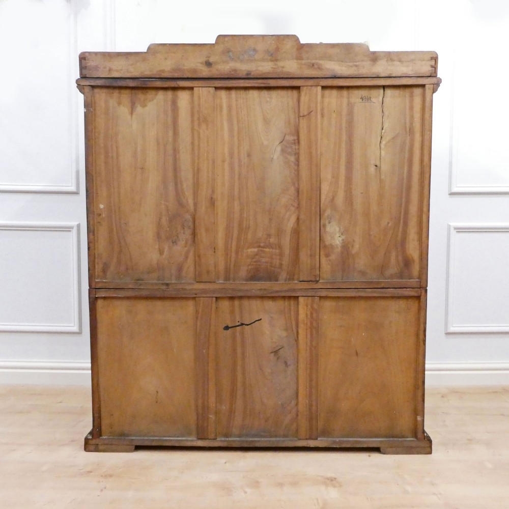A tall early twentieth-century camphor wood chest of drawers featuring elaborate relief-carved oriental landscapes on the drawer fronts and side panels. View XIV