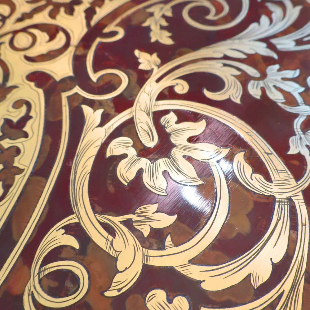 A French Louis XV style Boulle games table featuring brass and tortoiseshell marquetry, gilded ormolu mounts, and cabriole legs. View V