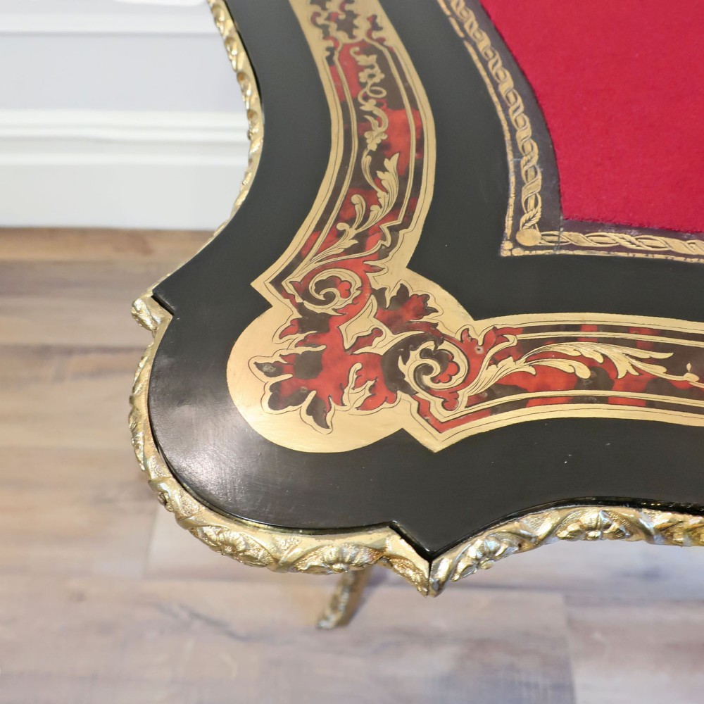 A French Louis XV style Boulle games table featuring brass and tortoiseshell marquetry, gilded ormolu mounts, and cabriole legs. View VIII