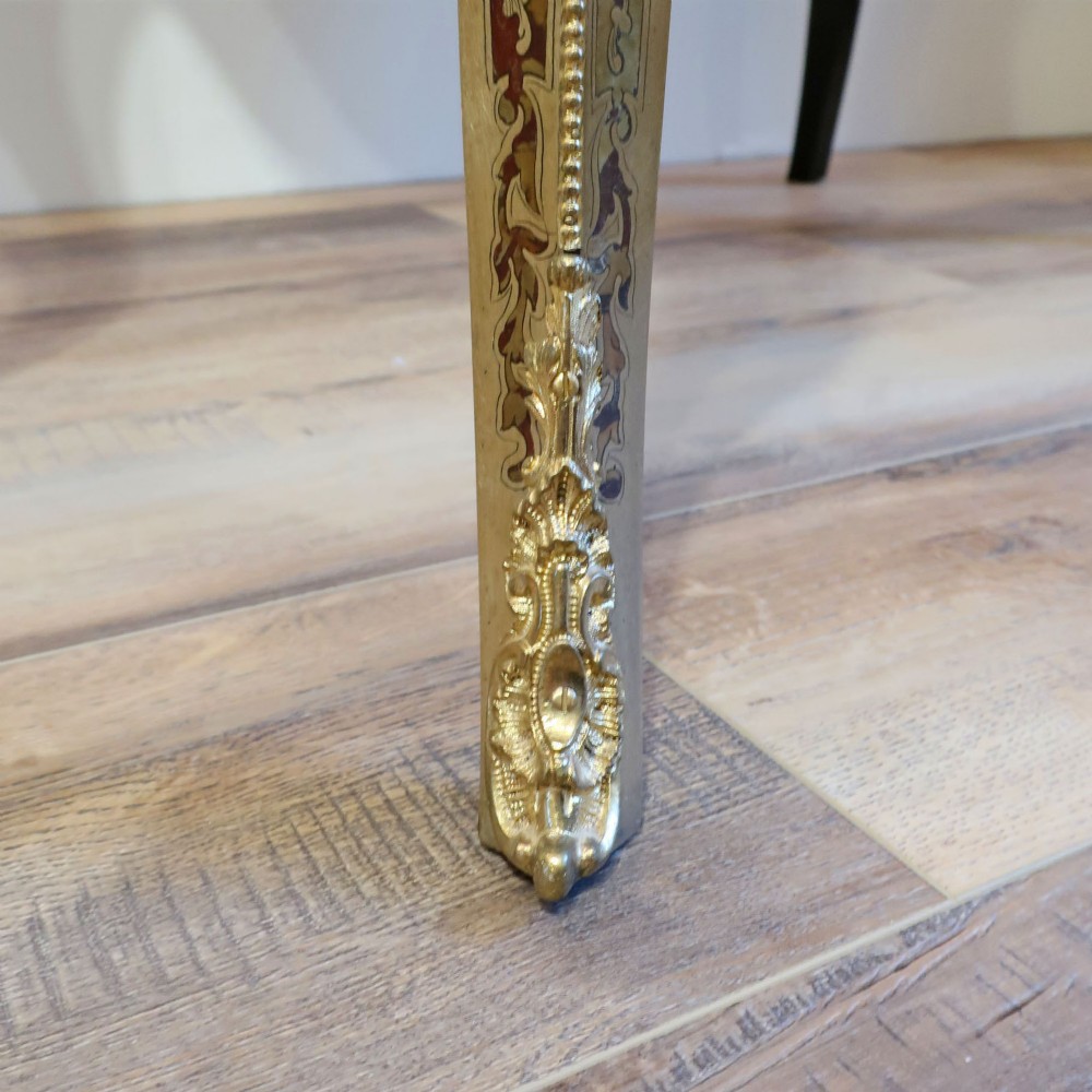 A French Louis XV style Boulle games table featuring brass and tortoiseshell marquetry, gilded ormolu mounts, and cabriole legs. View XII