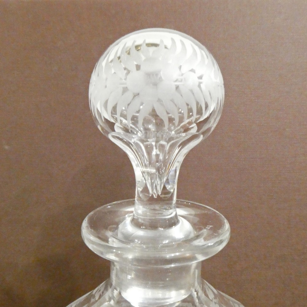 A Victorian silver-plated decanter stand with a central arched handle holding three etched glass decanters with stoppers. View VIII