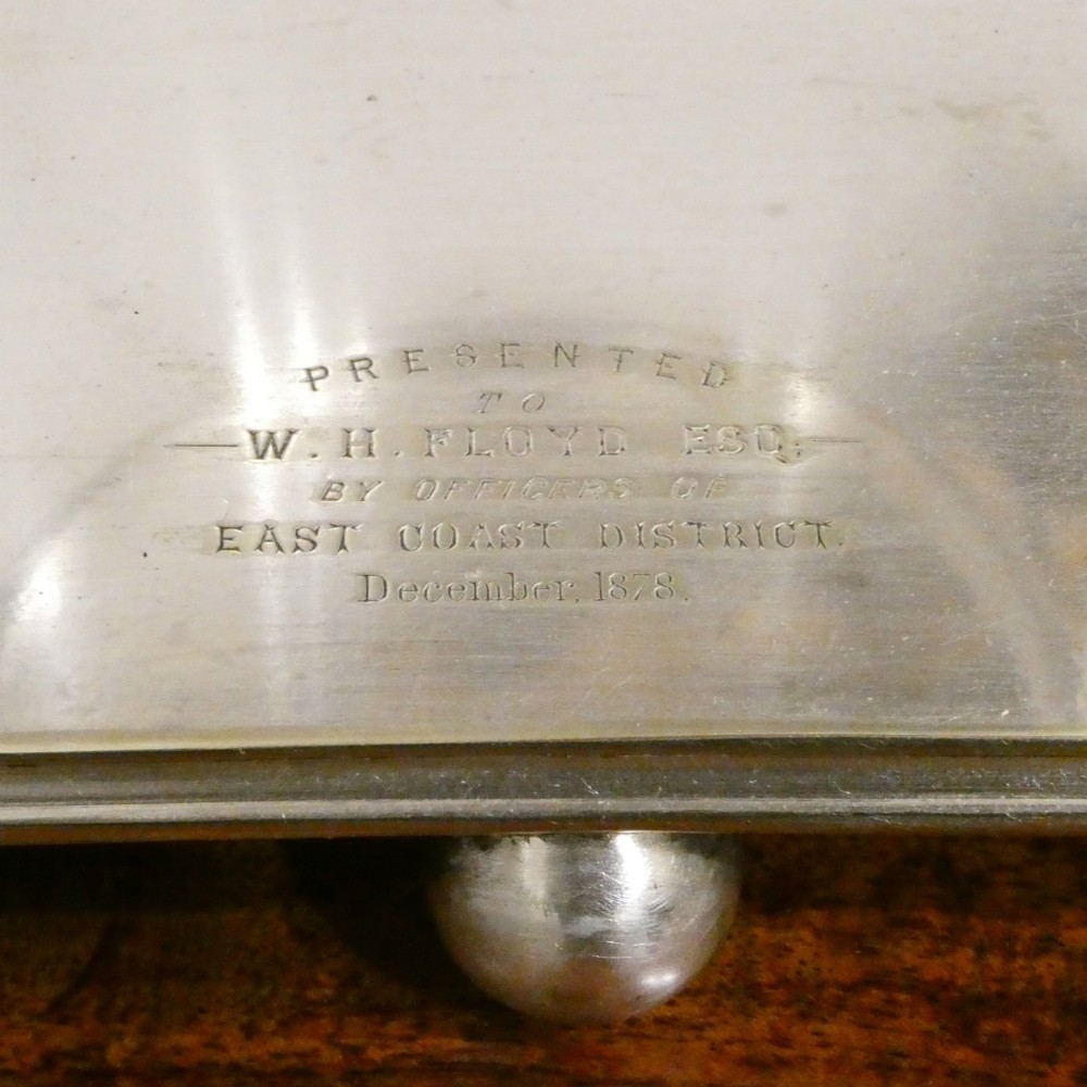 A Victorian silver-plated decanter stand with a central arched handle holding three etched glass decanters with stoppers. View XII