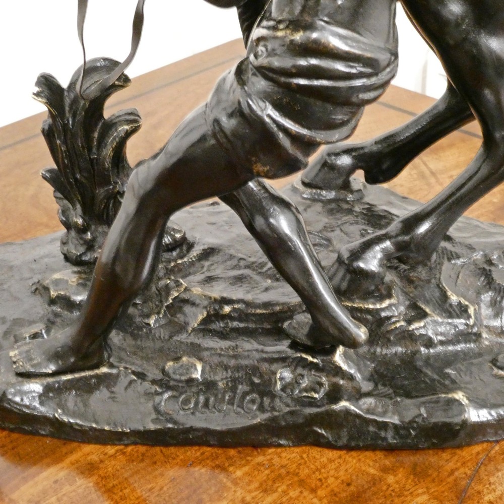 A pair of patinated dark bronze sculptures depicting rearing horses held by grooms on naturalistic bases. View VI