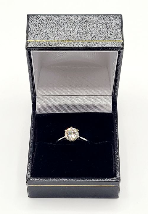 fig 1. A round brilliant diamond solitaire mounted in a six-claw setting on an 18ct white gold band.