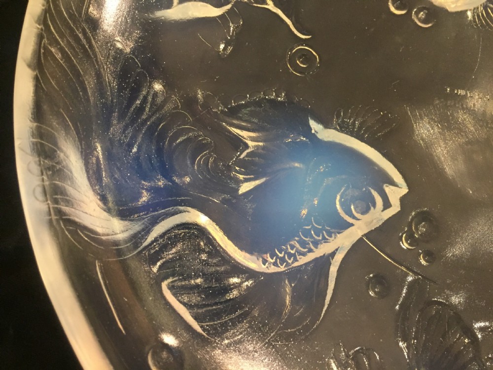 A circular Art Deco opalescent glass charger featuring relief-moulded fish and bubble motifs arranged in a continuous radial pattern. View III