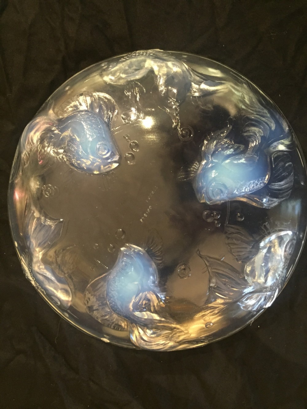 A circular Art Deco opalescent glass charger featuring relief-moulded fish and bubble motifs arranged in a continuous radial pattern. View IV