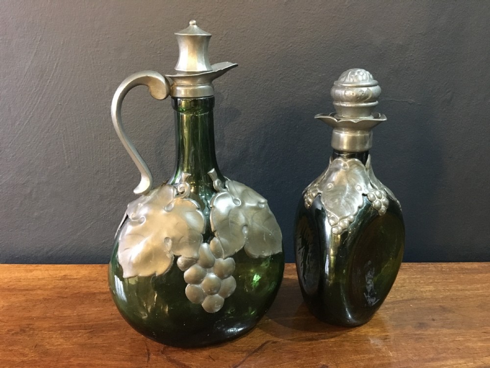 Two Art Nouveau Glass Bottles with Pewter Overlay Decoration & Stoppers C19th