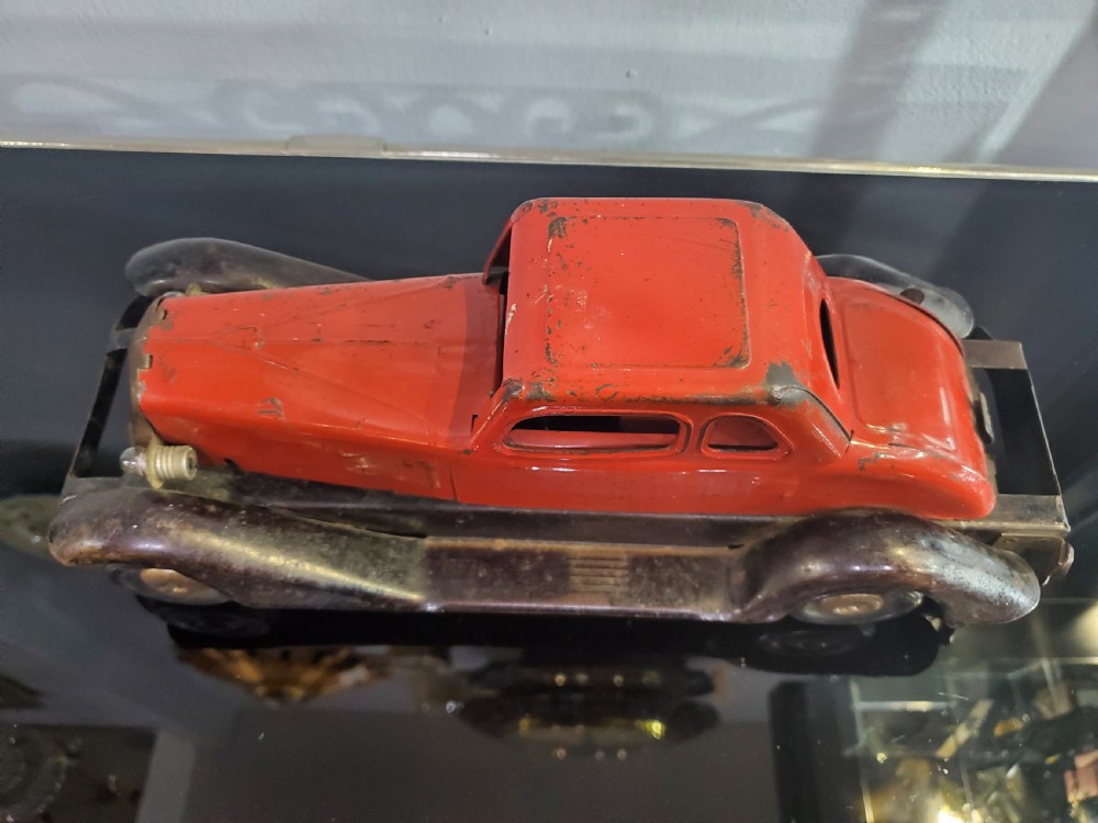 A 1930s red and black pressed steel Fire Chief toy coupe car with clockwork lever and original side decal. View XIII