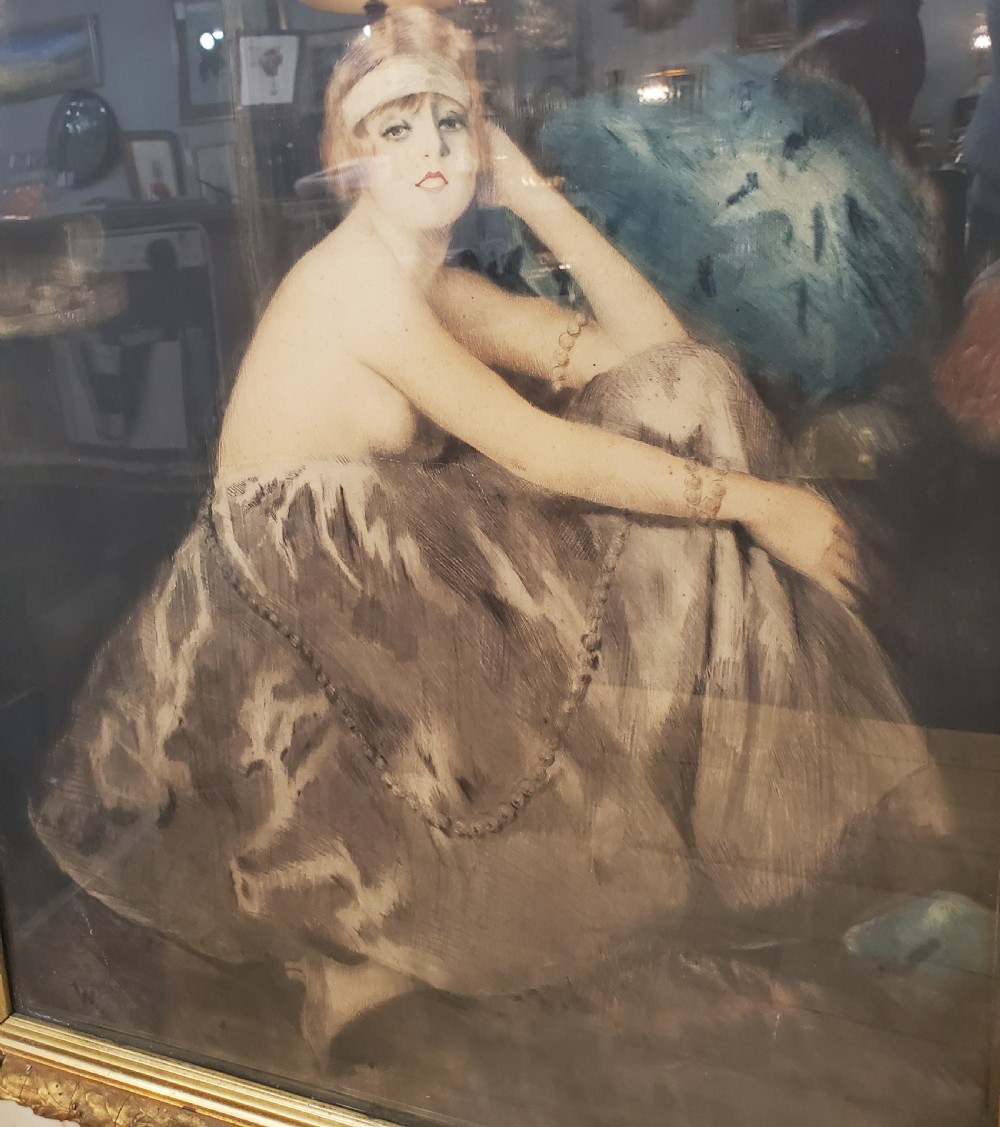 A large Art Deco framed portrait print depicting a seated woman in a patterned skirt, set inside a gold leaf inner moulding and a broad cream-painted outer frame. View III
