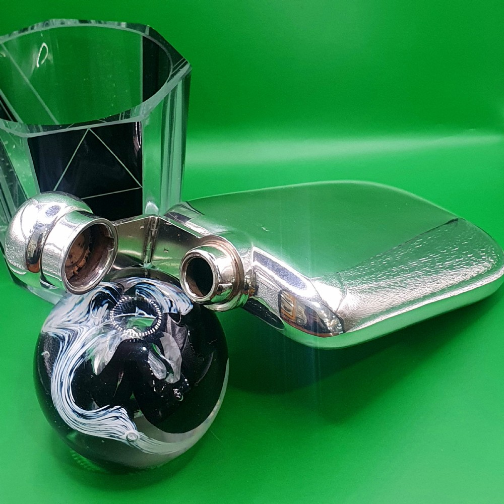 A polished sterling silver hip flask featuring a curved rectangular shape and a hinged bayonet top cap. View II