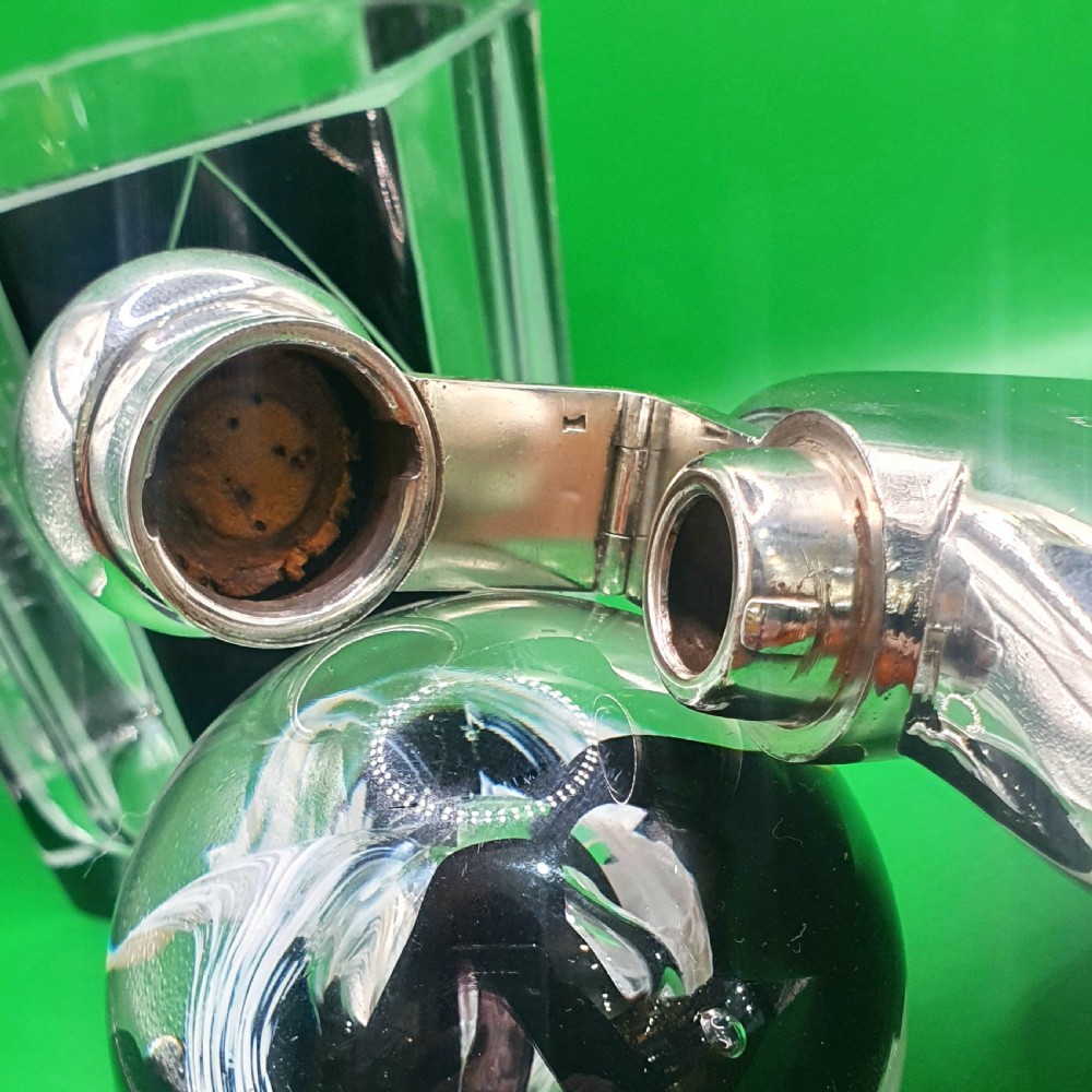 A polished sterling silver hip flask featuring a curved rectangular shape and a hinged bayonet top cap. View III