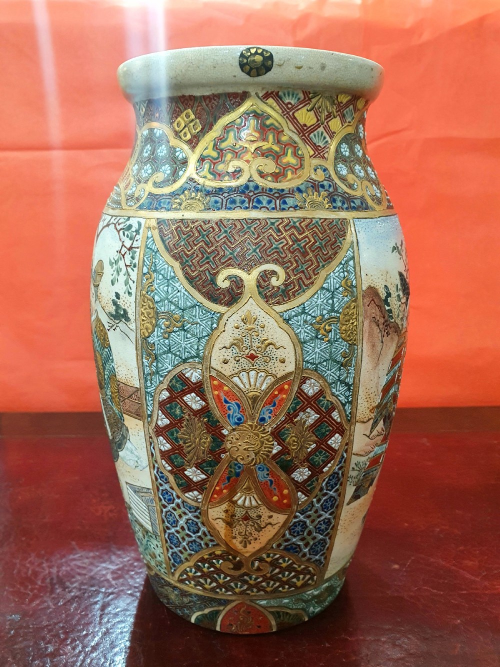 A pair of Japanese Satsuma earthenware vases decorated with detailed gilded panels and painted figures. View II
