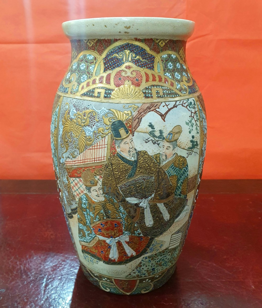 A pair of Japanese Satsuma earthenware vases decorated with detailed gilded panels and painted figures. View III