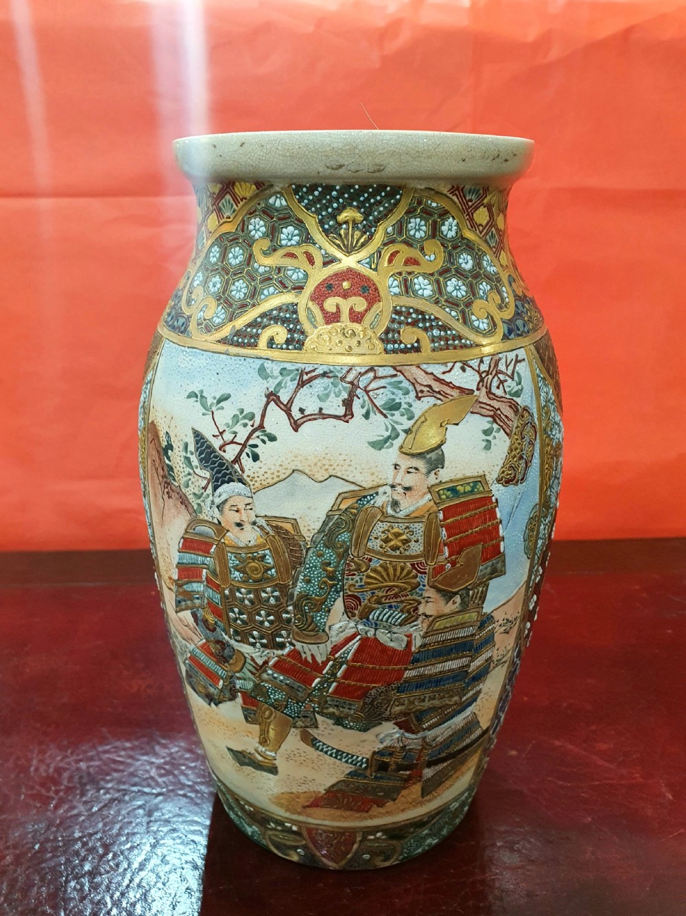 A pair of Japanese Satsuma earthenware vases decorated with detailed gilded panels and painted figures. View V
