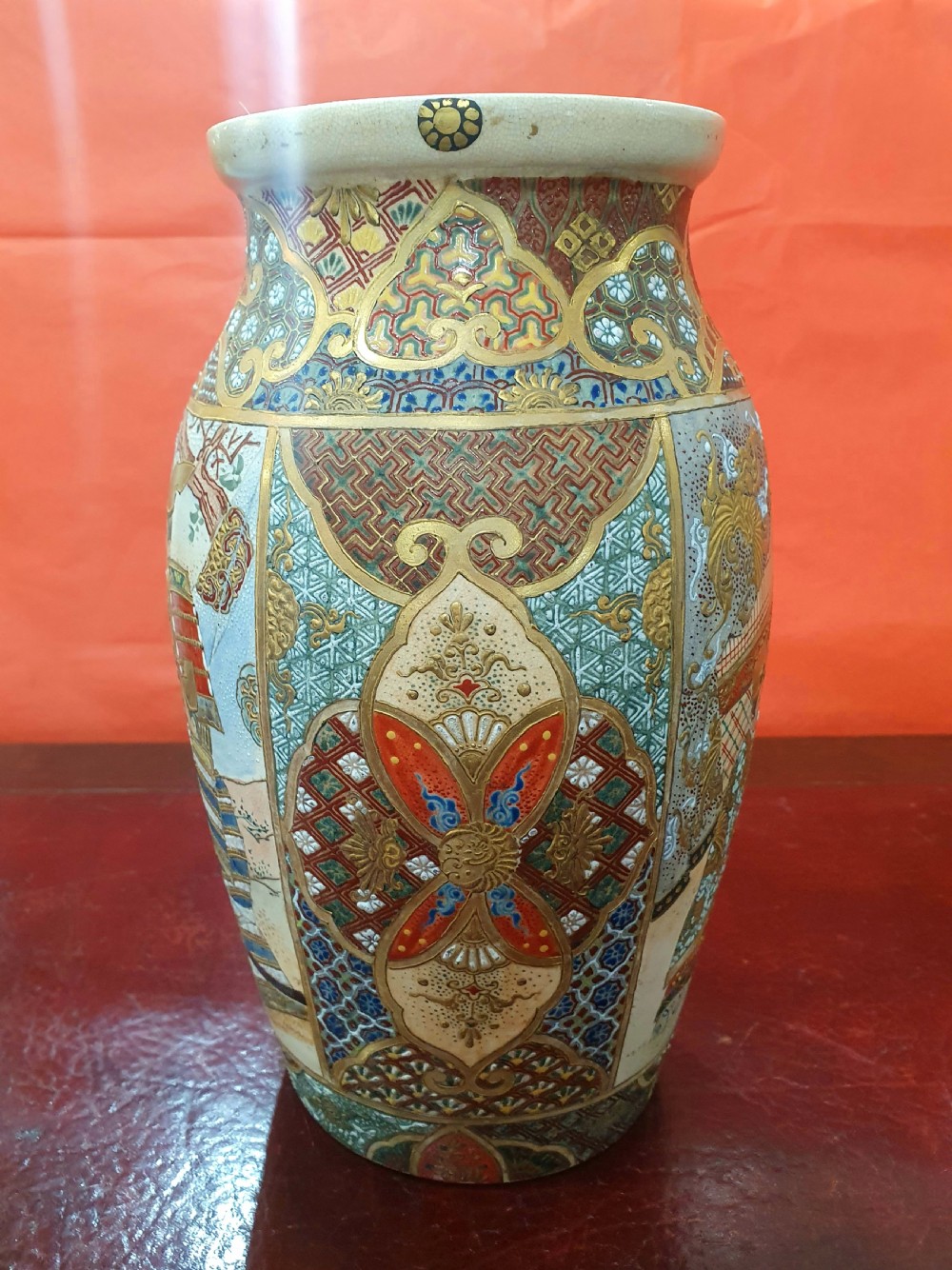 A pair of Japanese Satsuma earthenware vases decorated with detailed gilded panels and painted figures. View VI