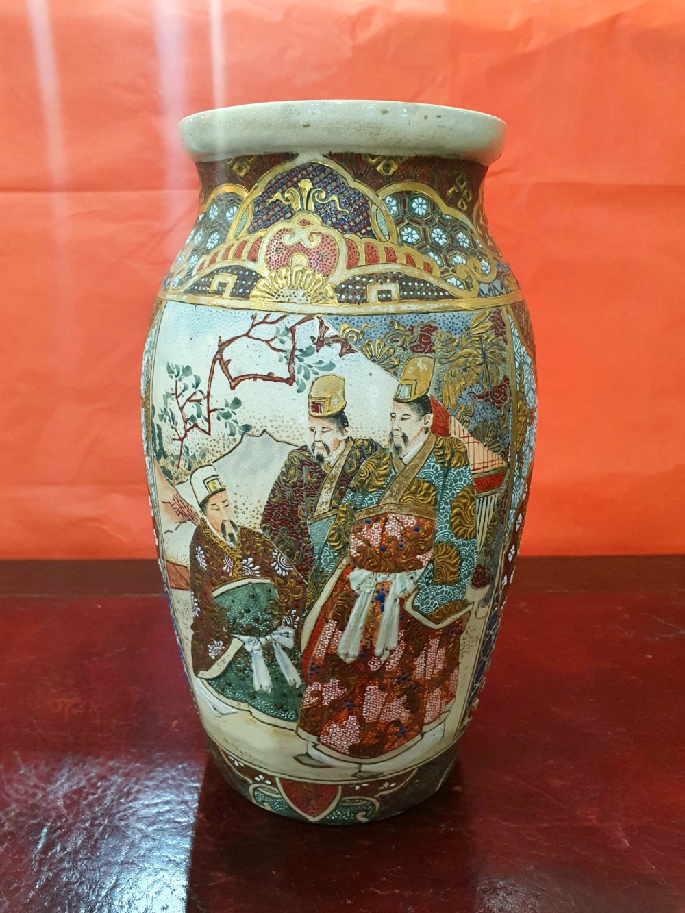 A pair of Japanese Satsuma earthenware vases decorated with detailed gilded panels and painted figures. View VII