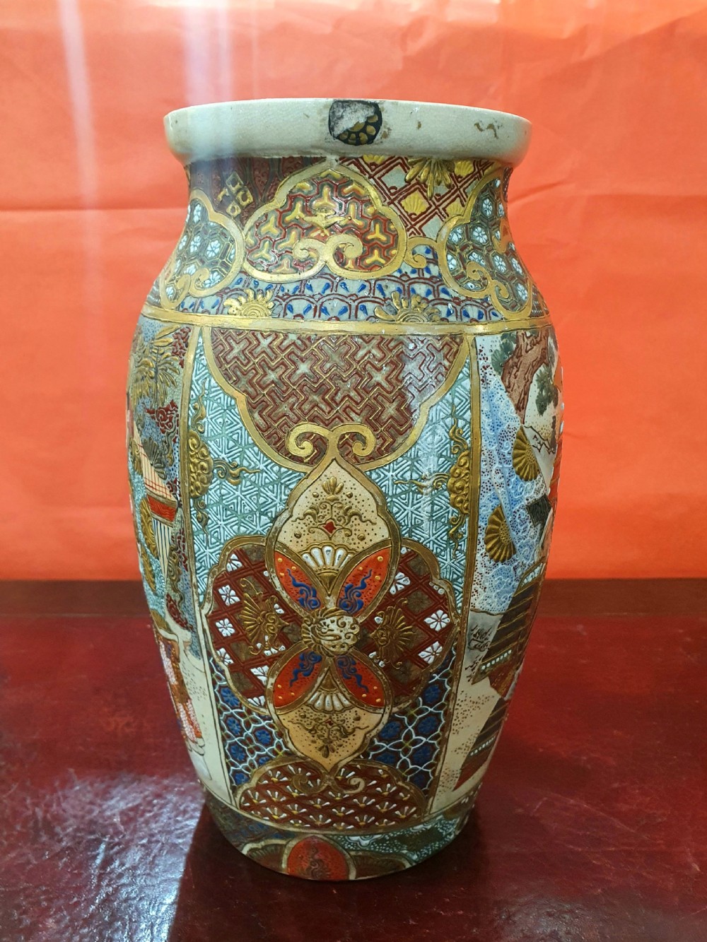 A pair of Japanese Satsuma earthenware vases decorated with detailed gilded panels and painted figures. View VIII