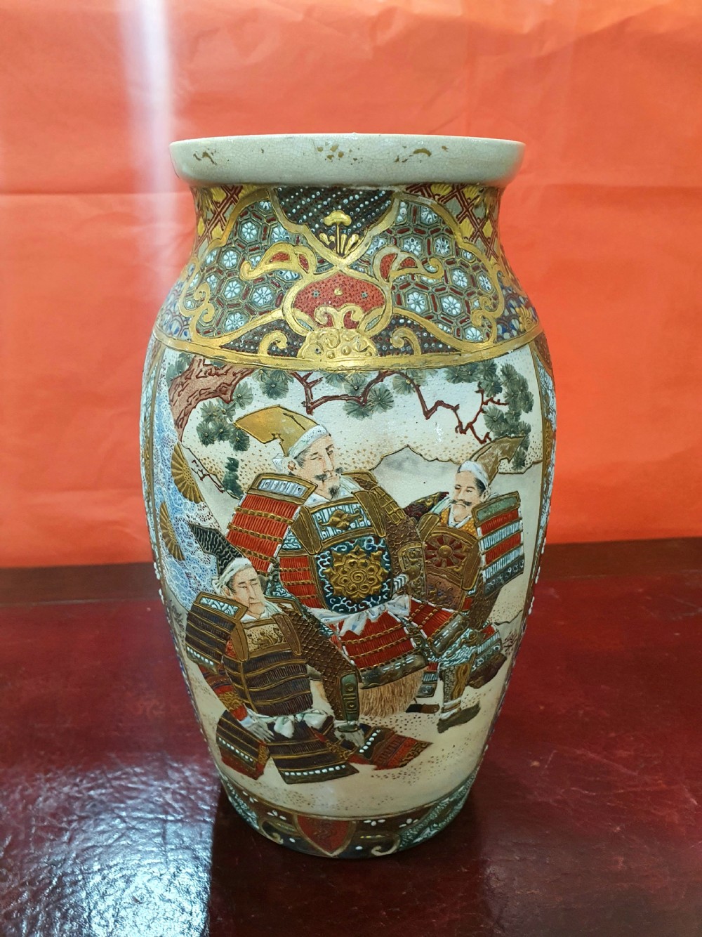 A pair of Japanese Satsuma earthenware vases decorated with detailed gilded panels and painted figures. View X