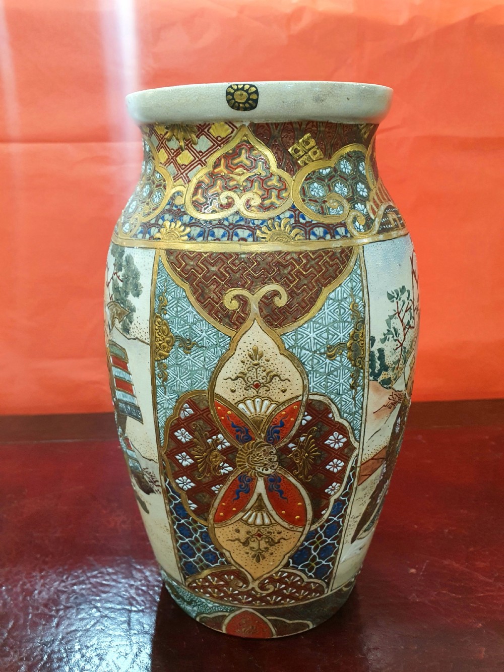 A pair of Japanese Satsuma earthenware vases decorated with detailed gilded panels and painted figures. View XI