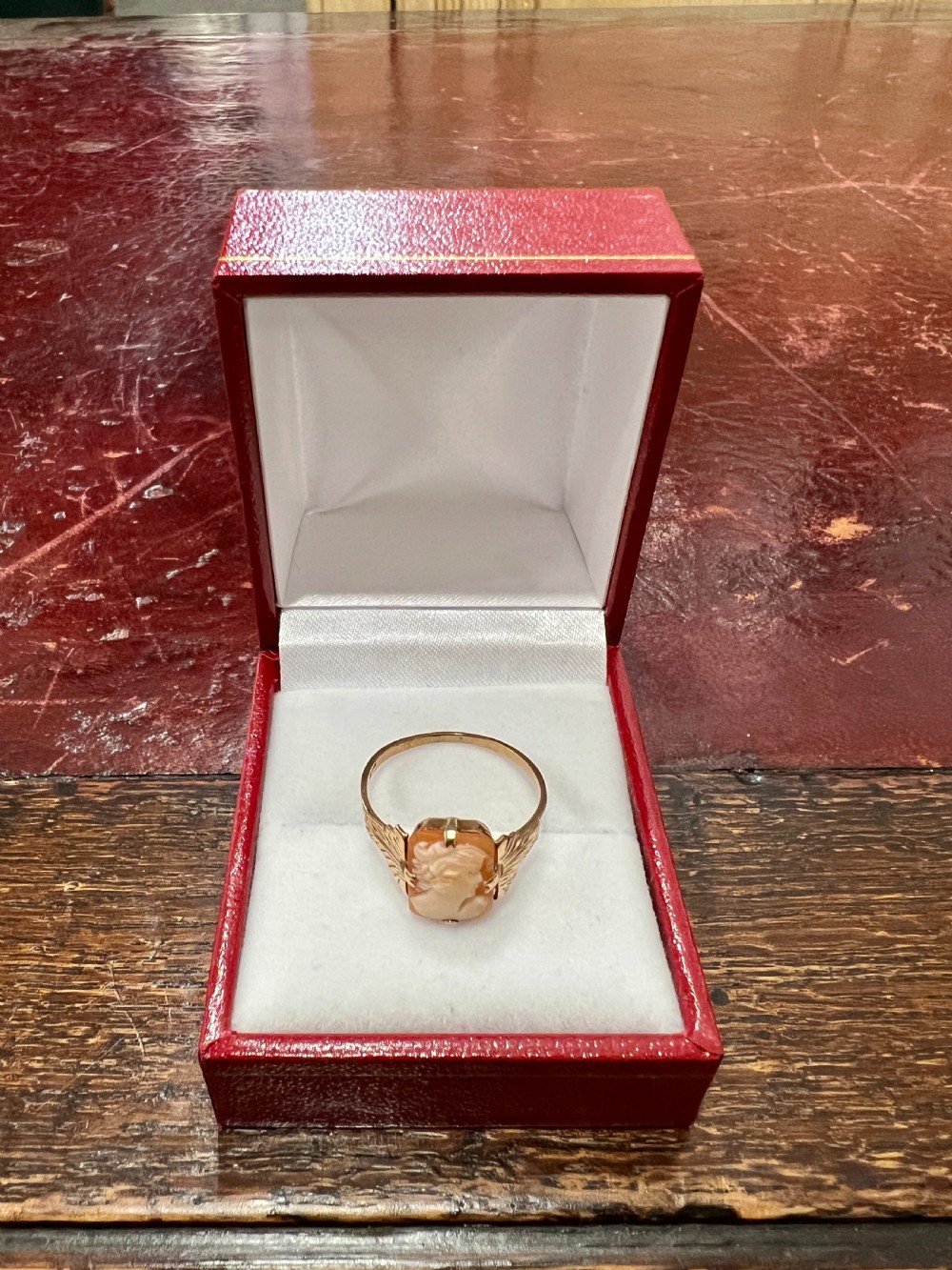 An Art Deco 9ct gold ring featuring a rectangular carved shell cameo displaying a female profile in relief. View II