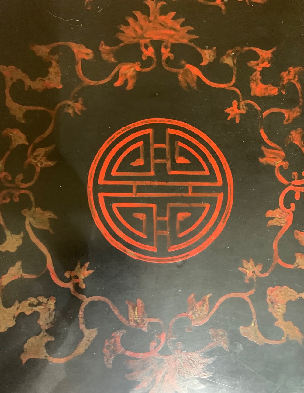 A low rectangular black lacquer centre chest featuring red geometric borders and hand-painted oriental landscape scenes on cabriole legs. View IX