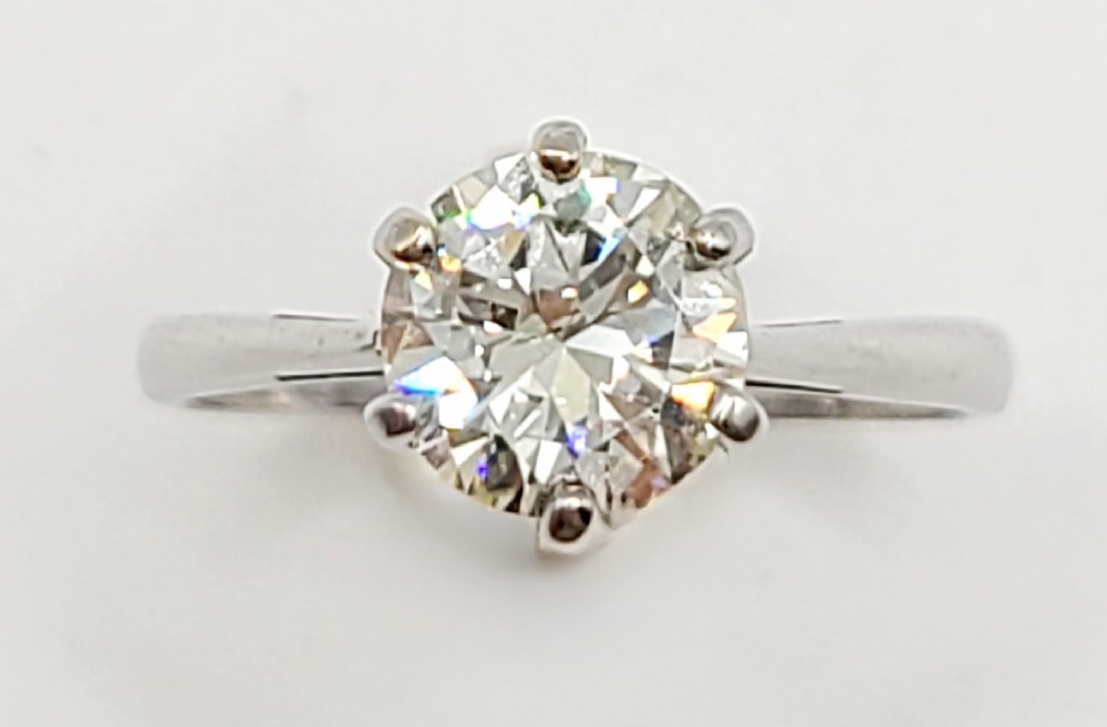 A round brilliant diamond solitaire mounted in a six-claw setting on an 18ct white gold band.