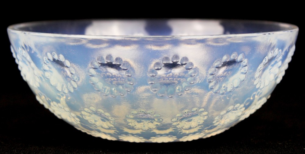 A circular Art Deco opalescent glass bowl featuring concentric moulded aster flower head motifs against a translucent light blue hue. View IV