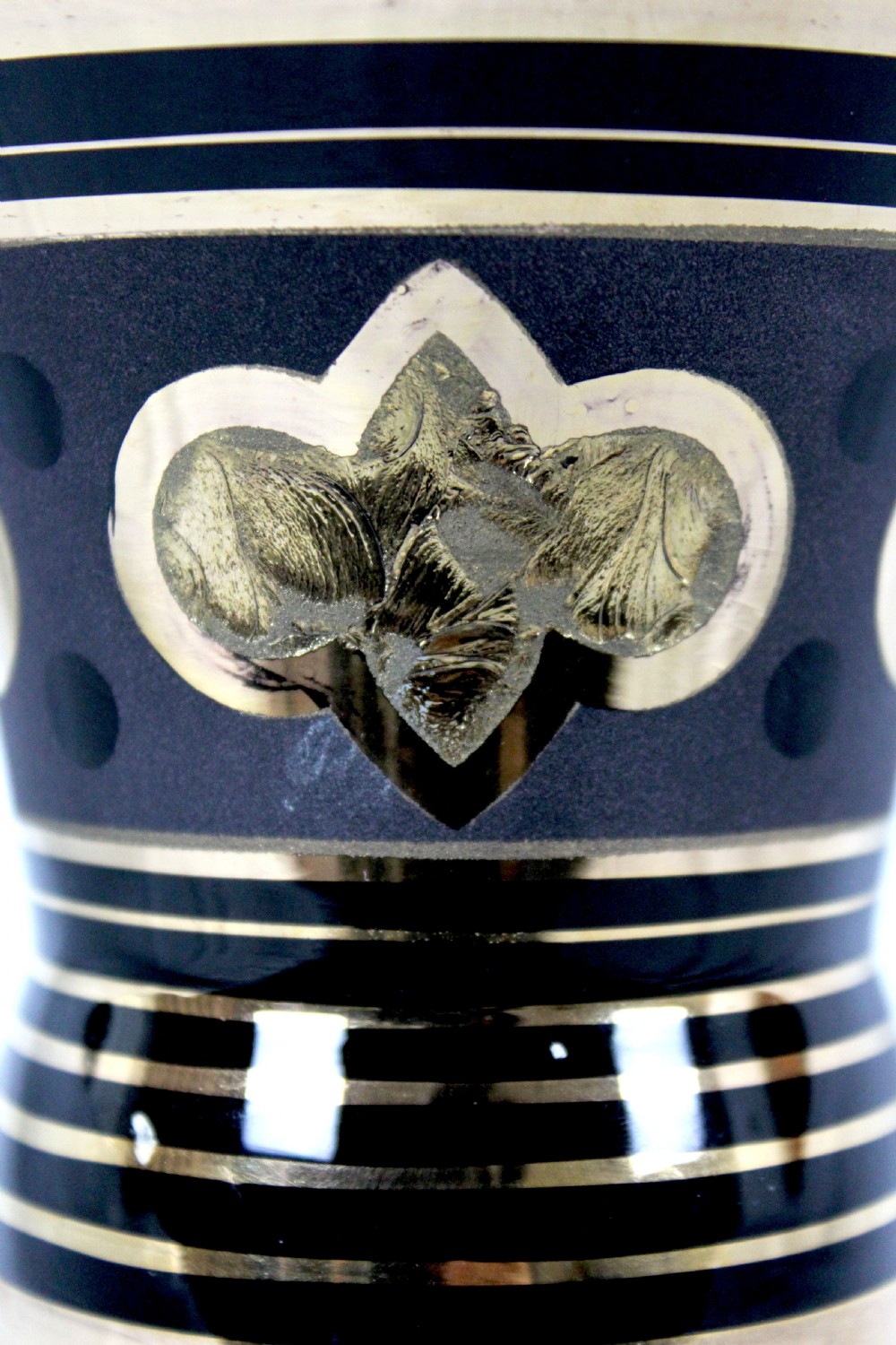 An Art Deco black hyalite glass vase featuring horizontal gold bands and stylized floral medallions. View V