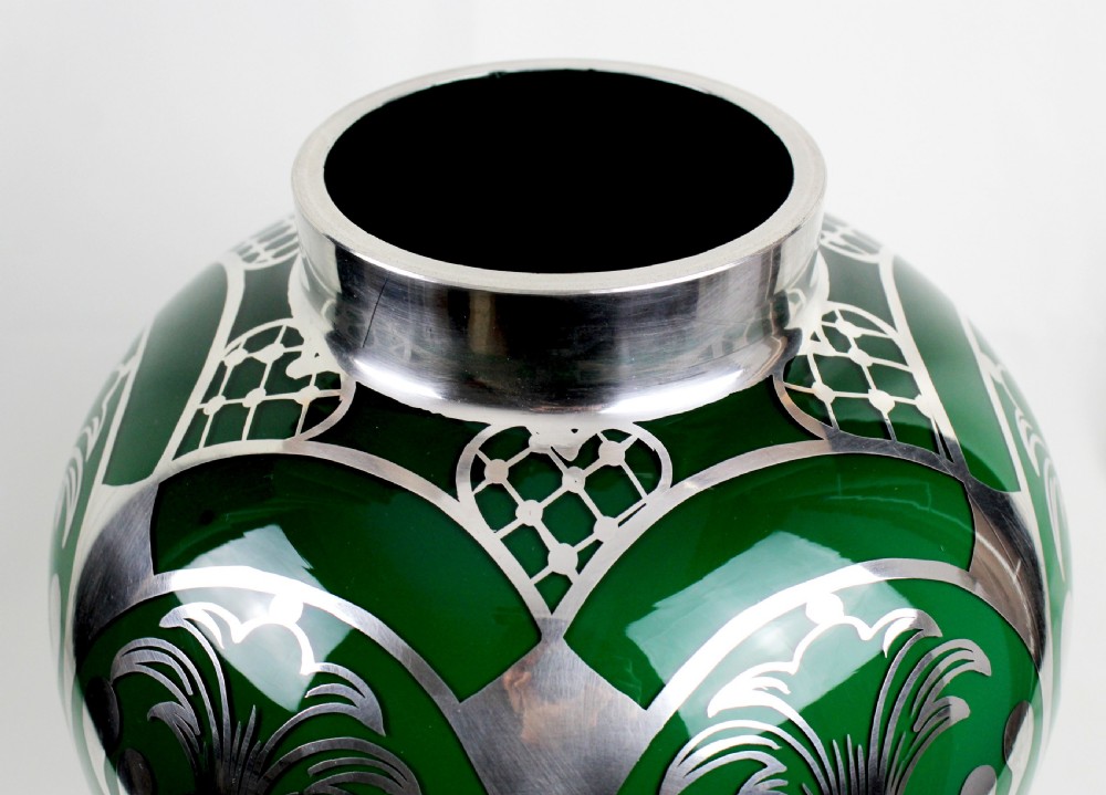 A deep green glass vase adorned with intricate sterling silver overlay featuring stylised foliage and lattice patterns. View IV