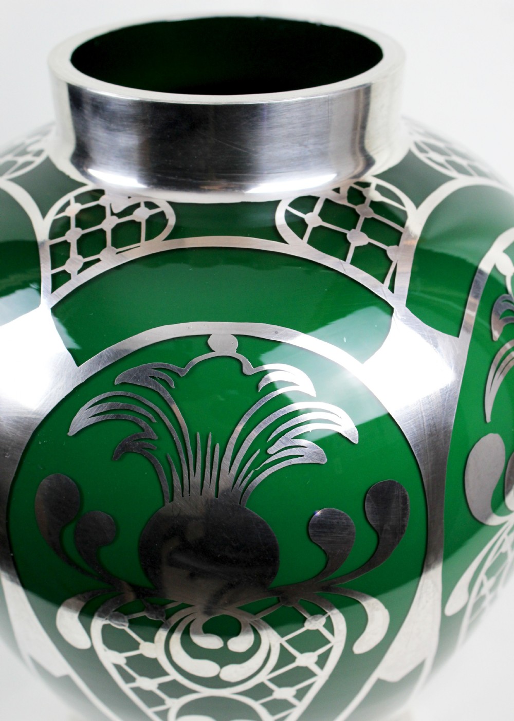A deep green glass vase adorned with intricate sterling silver overlay featuring stylised foliage and lattice patterns. View V