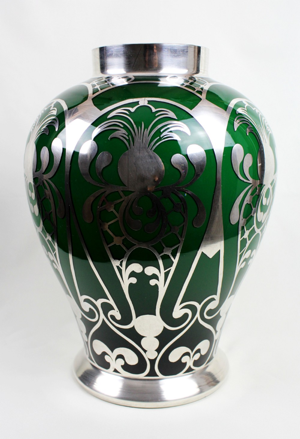 A deep green glass vase adorned with intricate sterling silver overlay featuring stylised foliage and lattice patterns. View VI