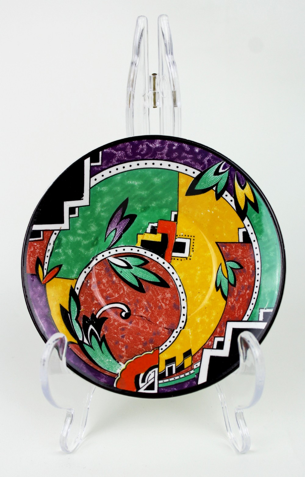 A multi-piece Art Deco ceramic coffee set decorated with vibrant red, yellow, green, and black abstract geometric patterns, comprising a tall coffee pot, creamer, sugar bowl, six demitasse cups, and matching saucers. View XI