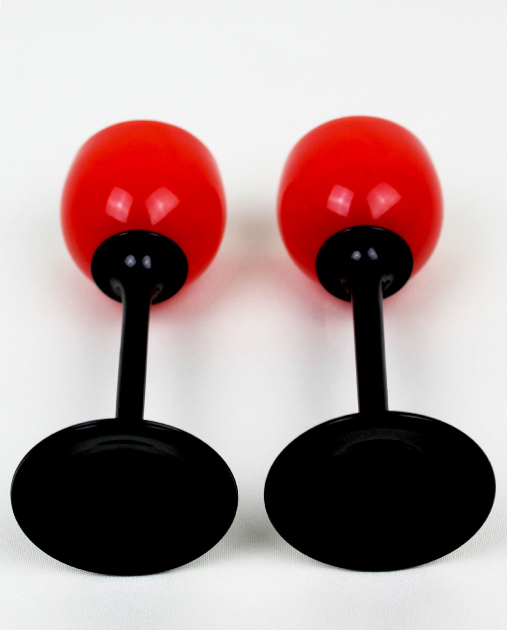 A pair of Art Deco Tango liqueur glasses featuring bright red rounded bowls supported by slender black stems and flat circular black bases. View V