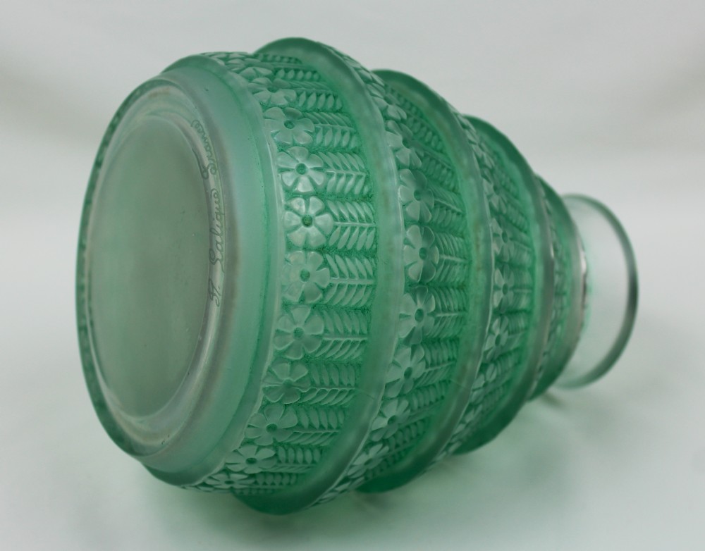 A green frosted glass Art Deco vase featuring tiered conical bands decorated with relief floral and leaf patterns. View V