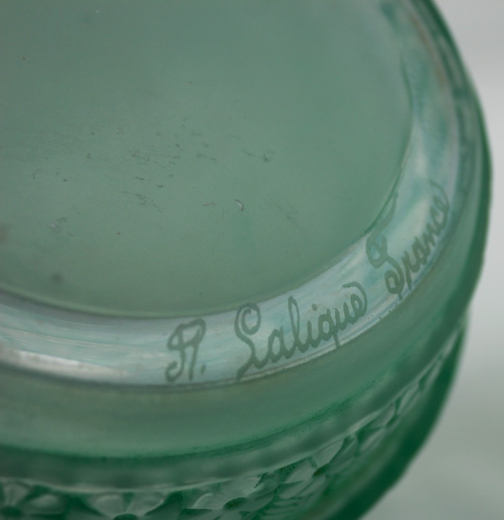 A green frosted glass Art Deco vase featuring tiered conical bands decorated with relief floral and leaf patterns. View VI