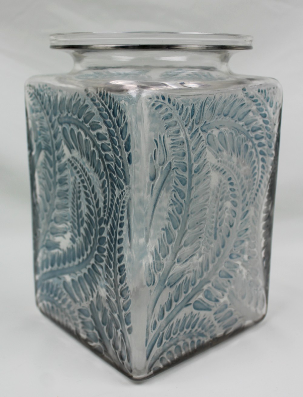 A square Rene Lalique Myrrhis clear glass vase featuring relief-moulded botanical motifs highlighted with blue staining.