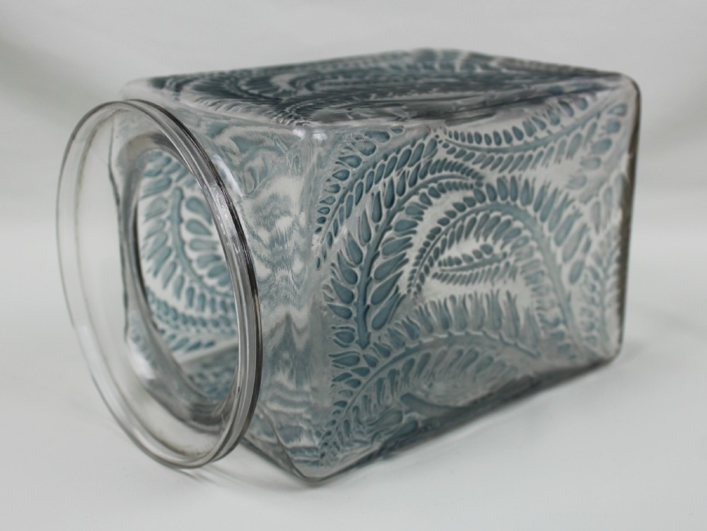 A square Rene Lalique Myrrhis clear glass vase featuring relief-moulded botanical motifs highlighted with blue staining. View V