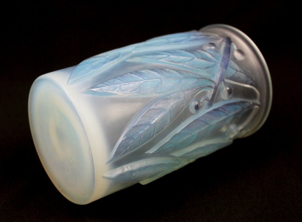 A cylindrical Art Deco opalescent glass vase decorated with relief-moulded laurel leaves and berries tinted in subtle blue. View V