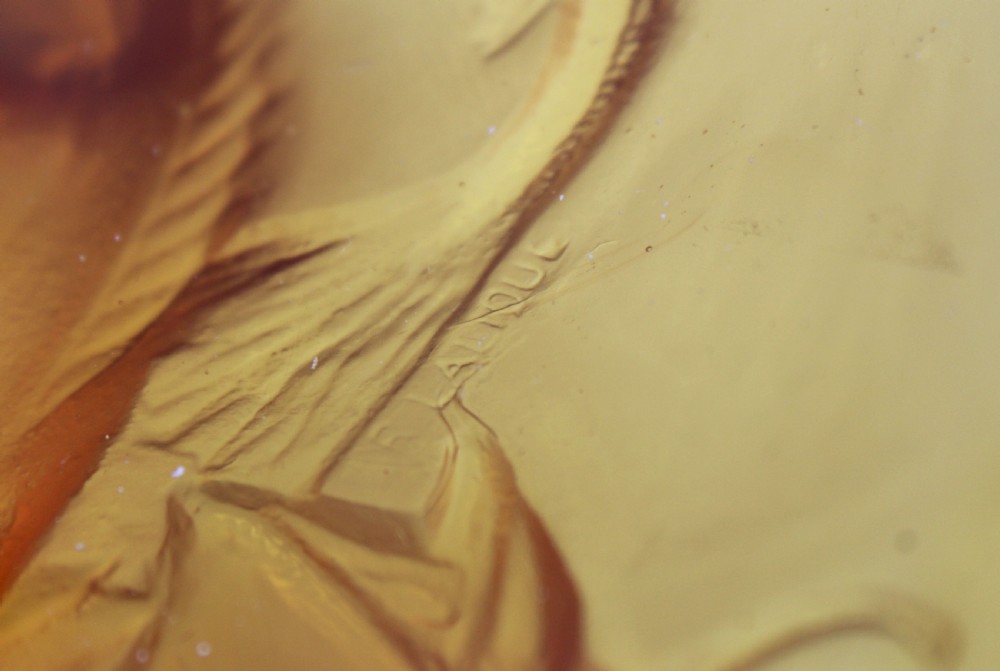 An Art Deco amber glass shallow dish featuring a relief motif of swimming fish radiating around the centre. View VII