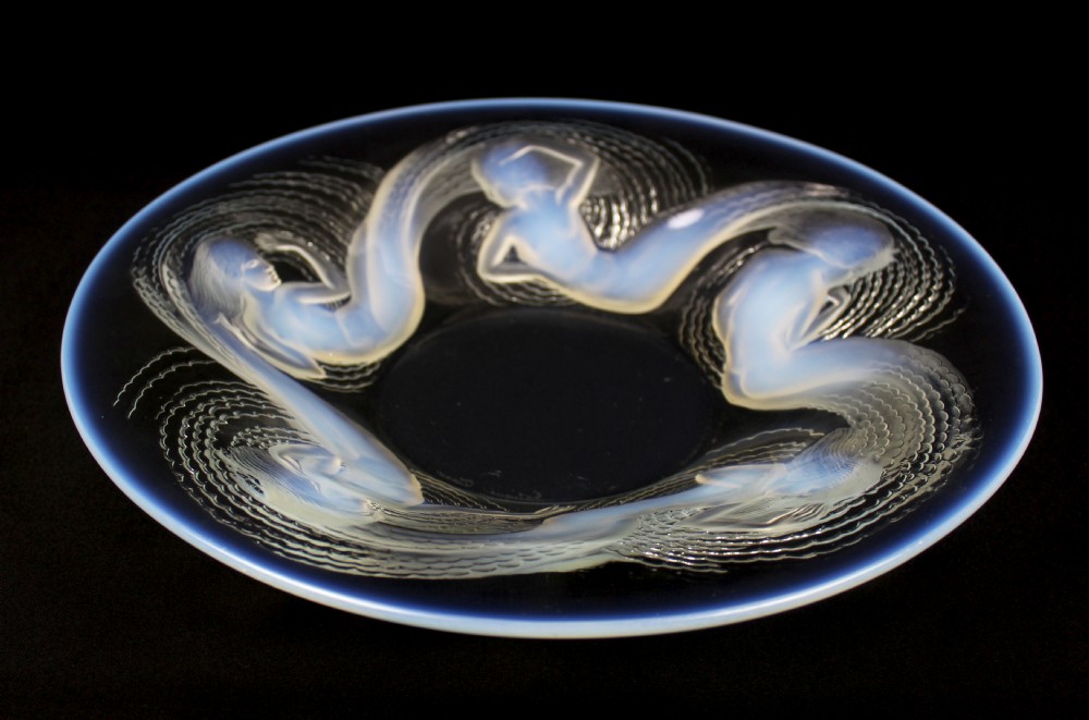 An Art Deco circular opalescent glass bowl featuring moulded relief figures of five swirling sirens surrounding the centre. View II