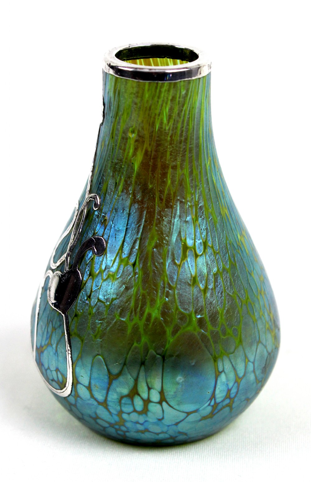 An iridescent blue and green glass vase featuring intricate silver overlay in a swirling Art Nouveau trefoil pattern. View II